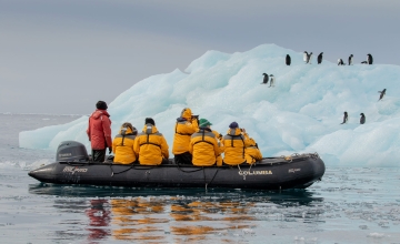 Zodiac cruising near penguins