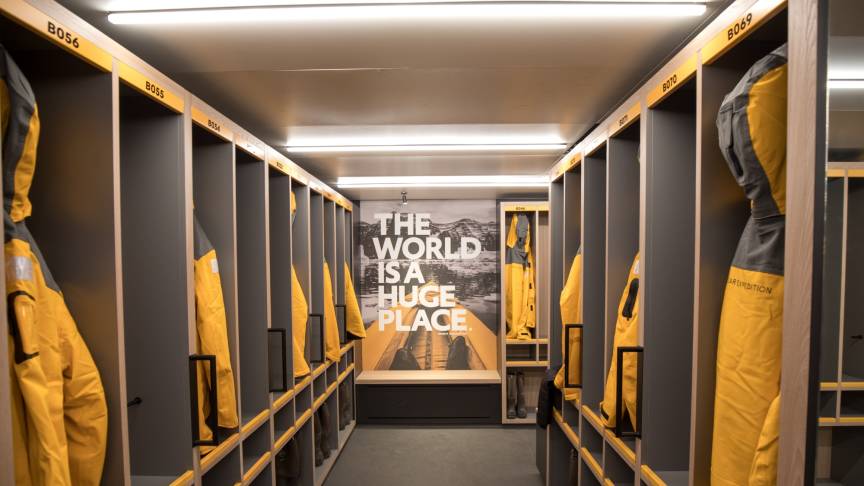 A ready room where Quark Expedition parks hang in their open lockers