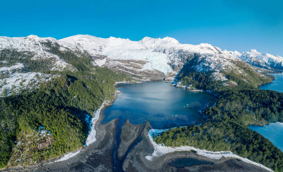 Snow capped mountains with a valley lake in Patagonia