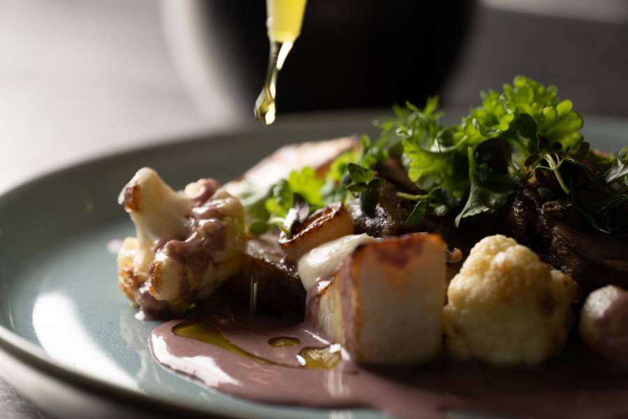 Baked lamb, cauliflower purée, turnip Parisienne, fried cauliflower and beurre rouge served with salt-baked Greenlandic potatoes