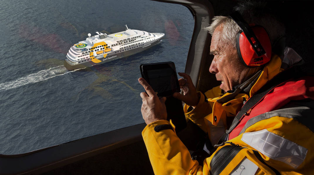 A guest takes photos of the ship Ultramarine while helicopter flightseeing.