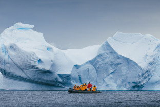 Quark Expeditions guests go Zodiac cruising with their Expedition Guide in the Antarctica Peninsula.