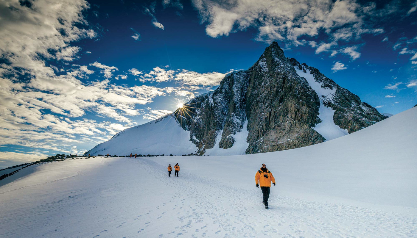 Passengers hiking in Antarctic Landscape