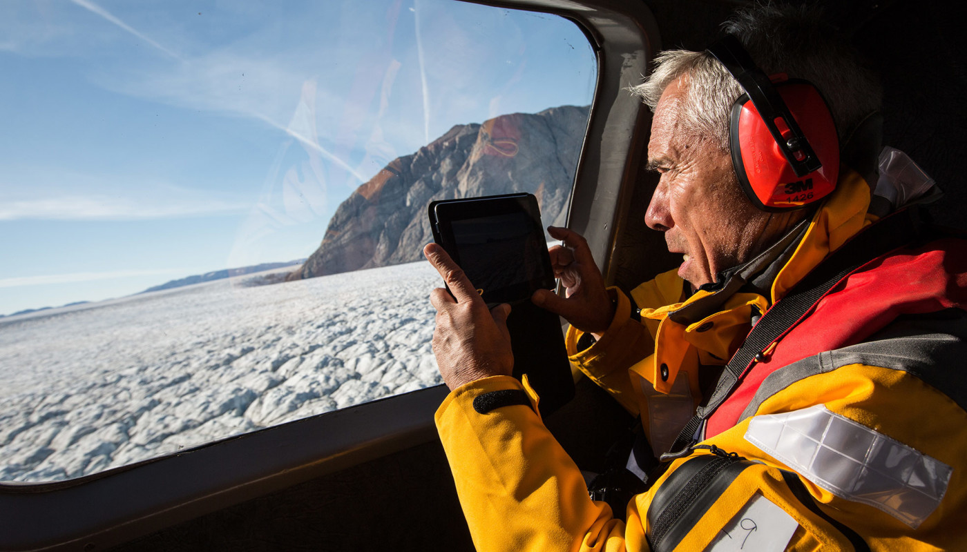 Passenger taking a photo of Arctic landscape from Helicopter
